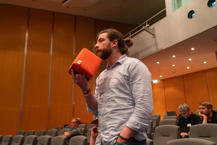 Attendee asking a question with the famous catch box microphone