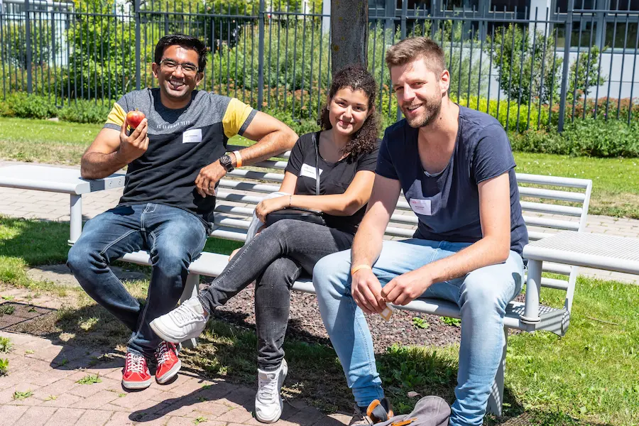 UI5con attendees sitting on a bench outside